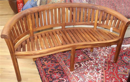 A teak garden banana bench W.160cm